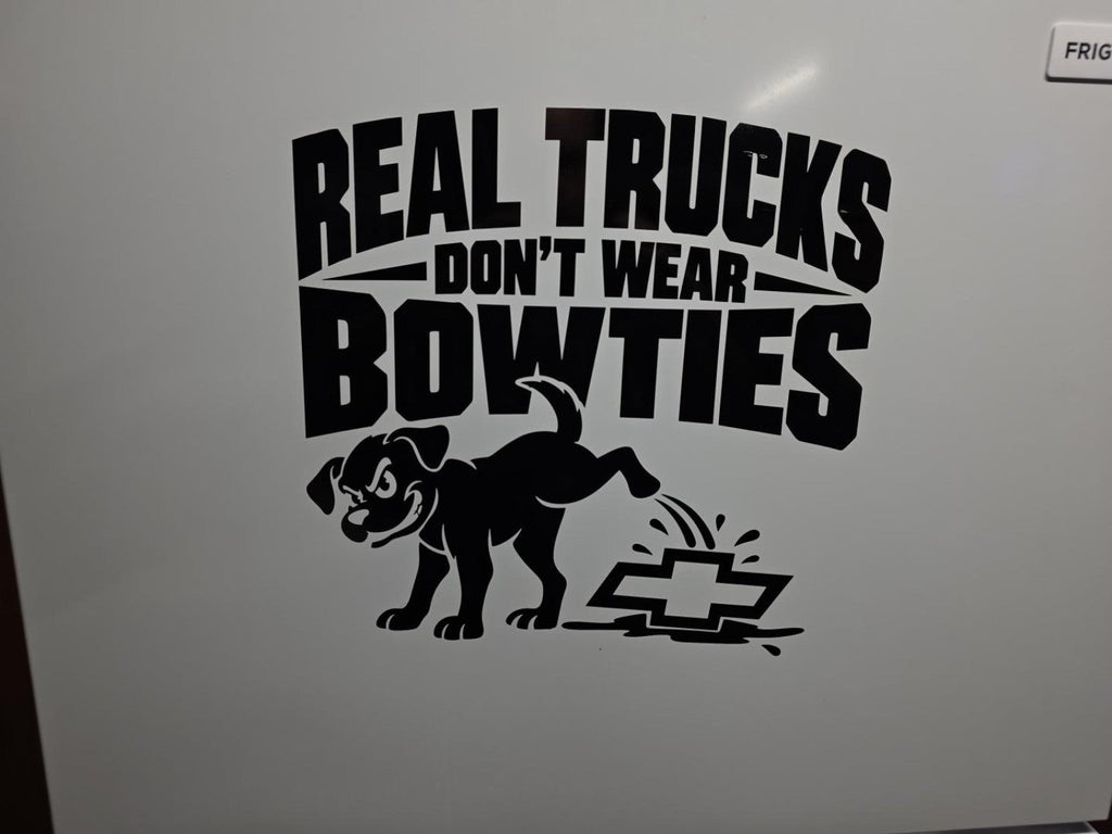 Our finished Real Trucks Don't Wear Bowties dog decal in black vinyl on a white garage refrigerator at Bullard Vinyl Co.