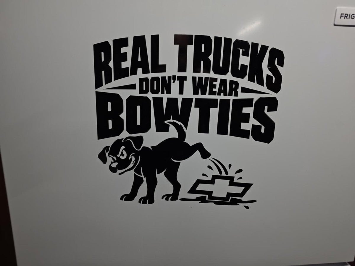 Our finished Real Trucks Don't Wear Bowties dog decal in black vinyl on a white garage refrigerator at Bullard Vinyl Co.